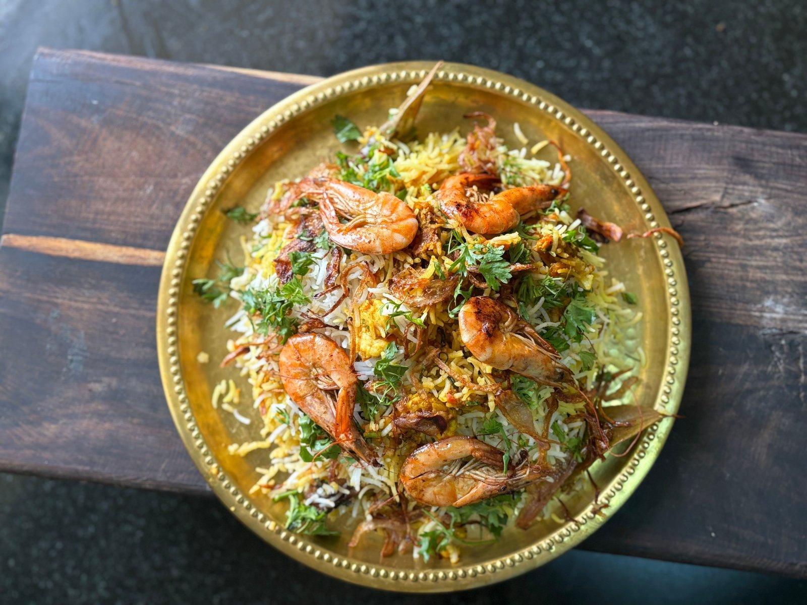 Overhead view of Ya Rahman biriyani platter garnished with fresh herbs