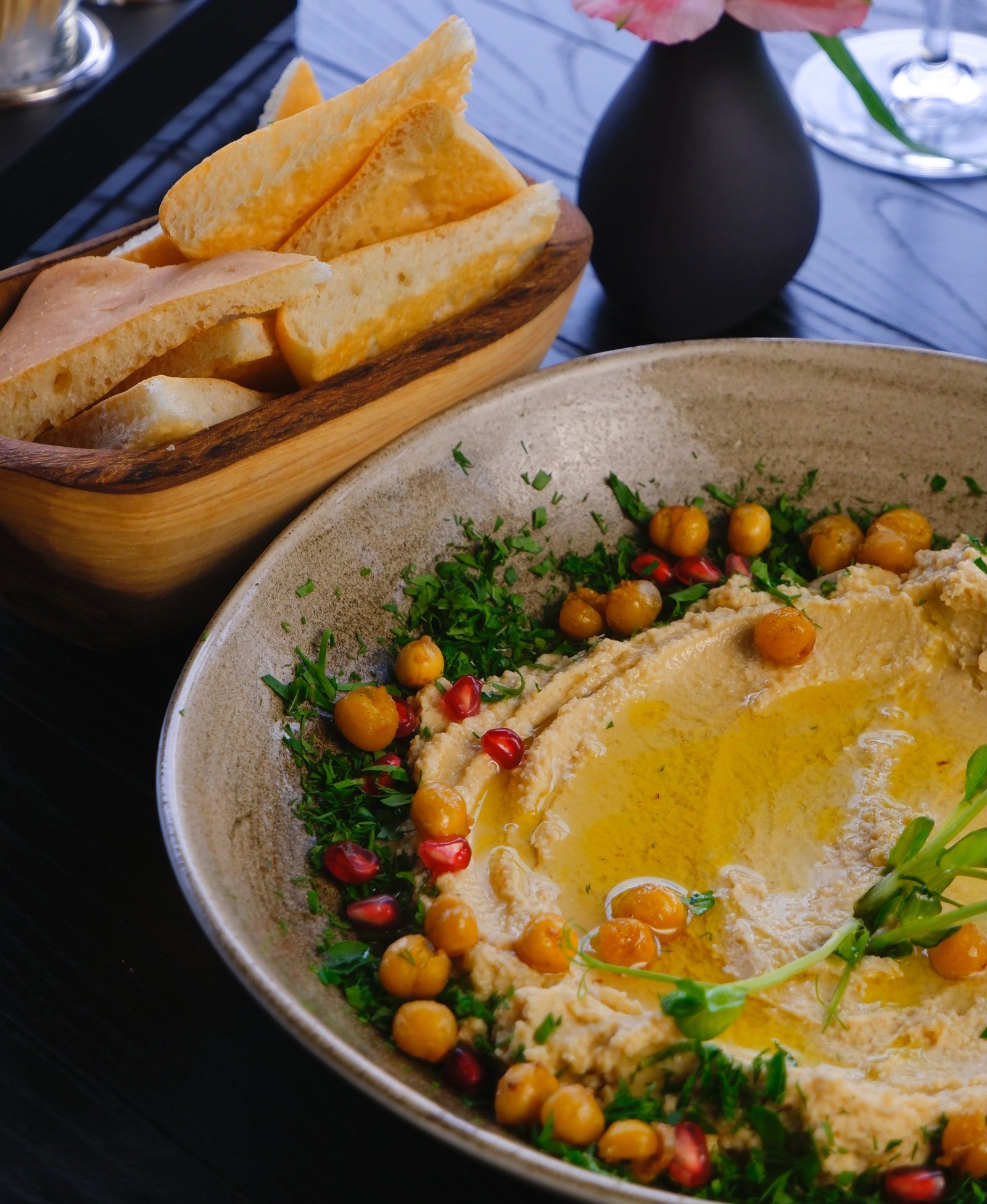 Creamy hummus garnished with herbs